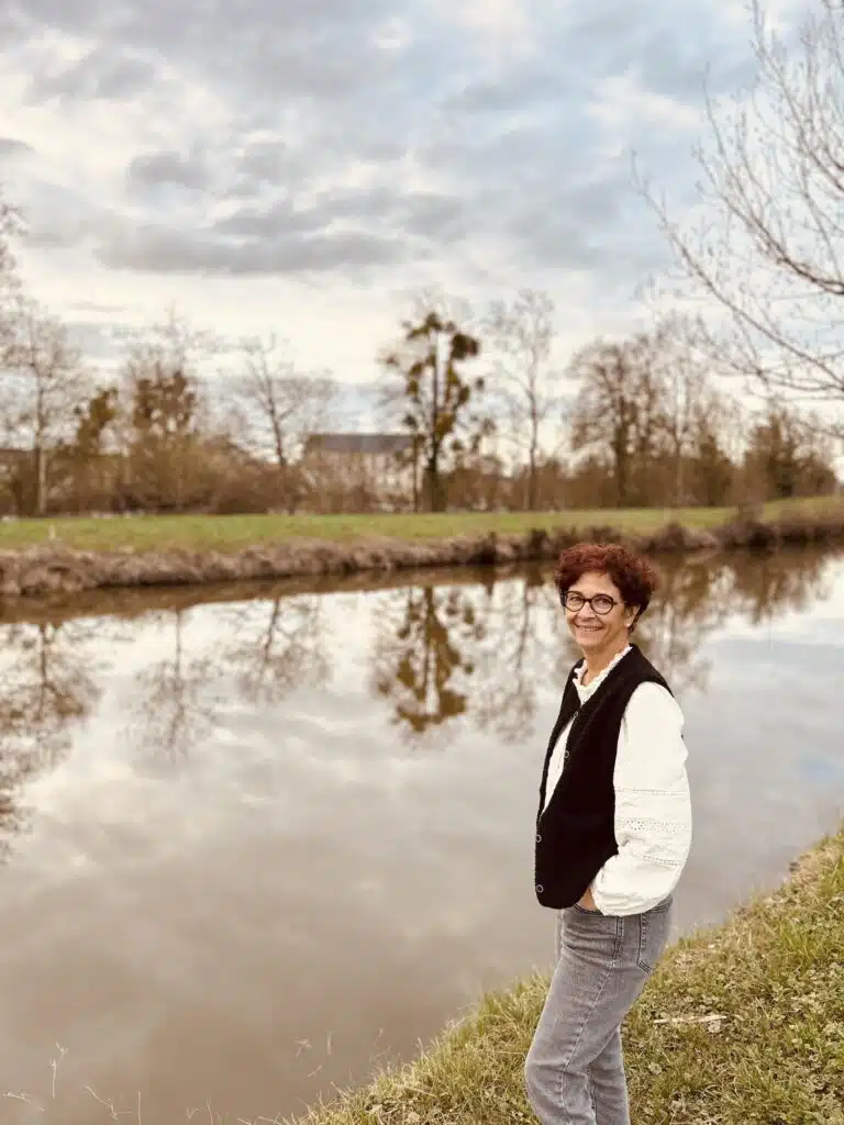 Valérie Pancelot, au bord de la rivière en train de faire un sourire.